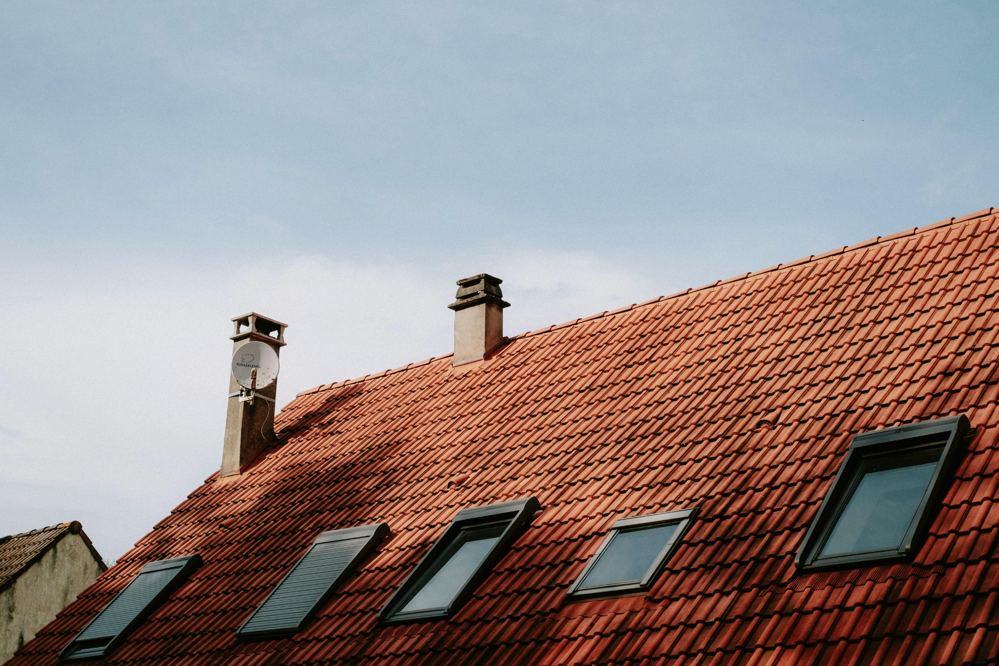 Completed red tile roof with windows